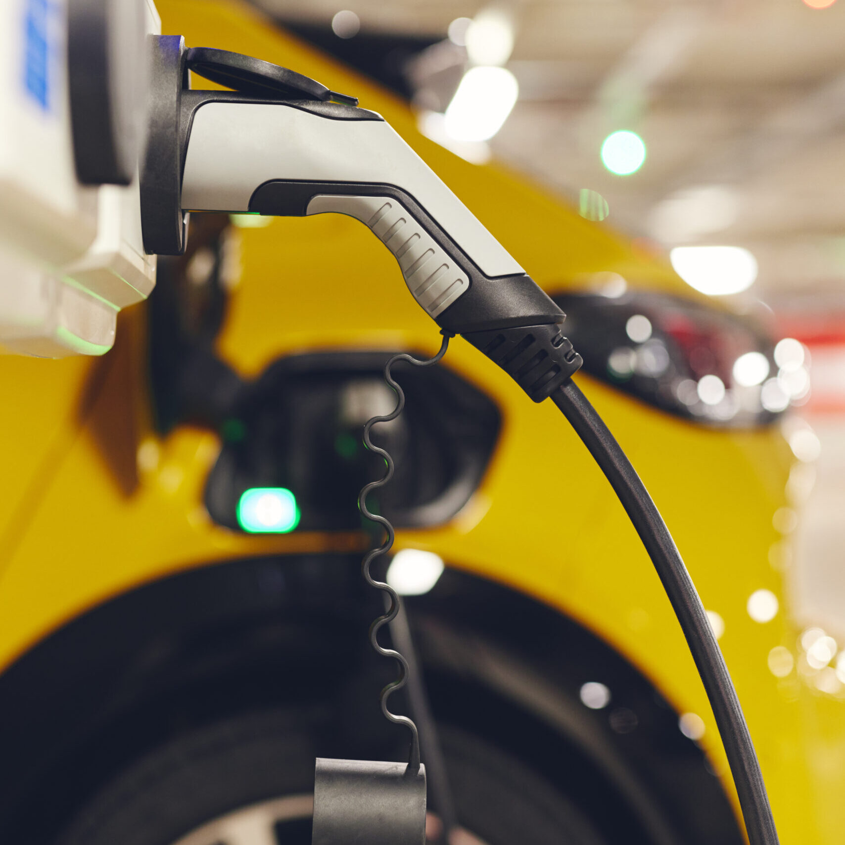 Electric car charging in underground car park in mall